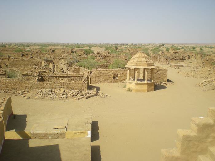 Kuldhara village near Jaisalmer has a very unique history! It is said that the residents of 84 neighboring villages including Kuldhara vacated the villages overnight around 170 years back!! No one is sure where they have gone, but they are believed to have migrated to a place somewhere near Jodhpur. The residents were Paliwal Brahmans — said to be very intelligent, and residing there for about 500 years. So what made them do such an act? Stories say that the ruler of these villages pounded the Paliwals with heavy taxes and treated them very inhumanly; the ruler was unethical and forceful to them. They had no alternative, but to vacate all the 84 villages overnight and just disappear from the vision and reach of the ruler.  When the Paliwals left the villages, they left a curse that nobody can inhabit the villages ever. Residents of Jaisalmer say that there have been some attempts by some families to stay there, but they did not succeed.