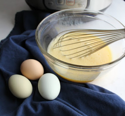 fresh eggs and lemon juice being whisked together to be added to soup