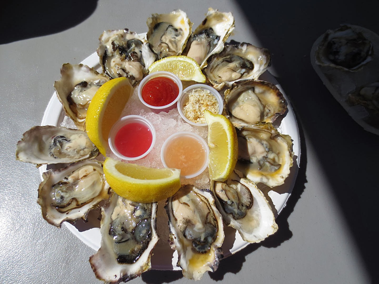 Raw oysters served with 3 types of vinaigrette, horseradish, and lemons