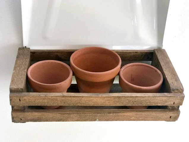 Wooden crate filled with terracotta pots