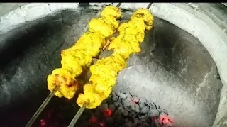 Cooking banjara kebab shewers in tandoor