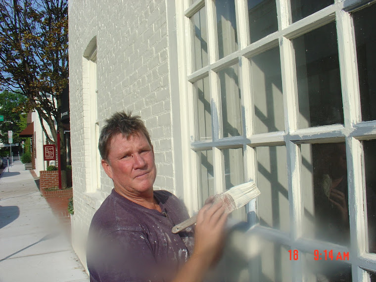 Richie painting exterior windows of retail shop, Long Island NY.JPG