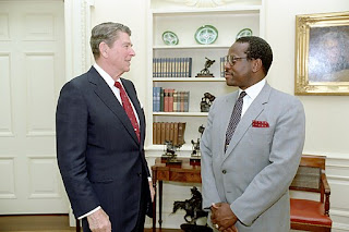 Reagan and Thomas standing facing each other in the Oval Office
