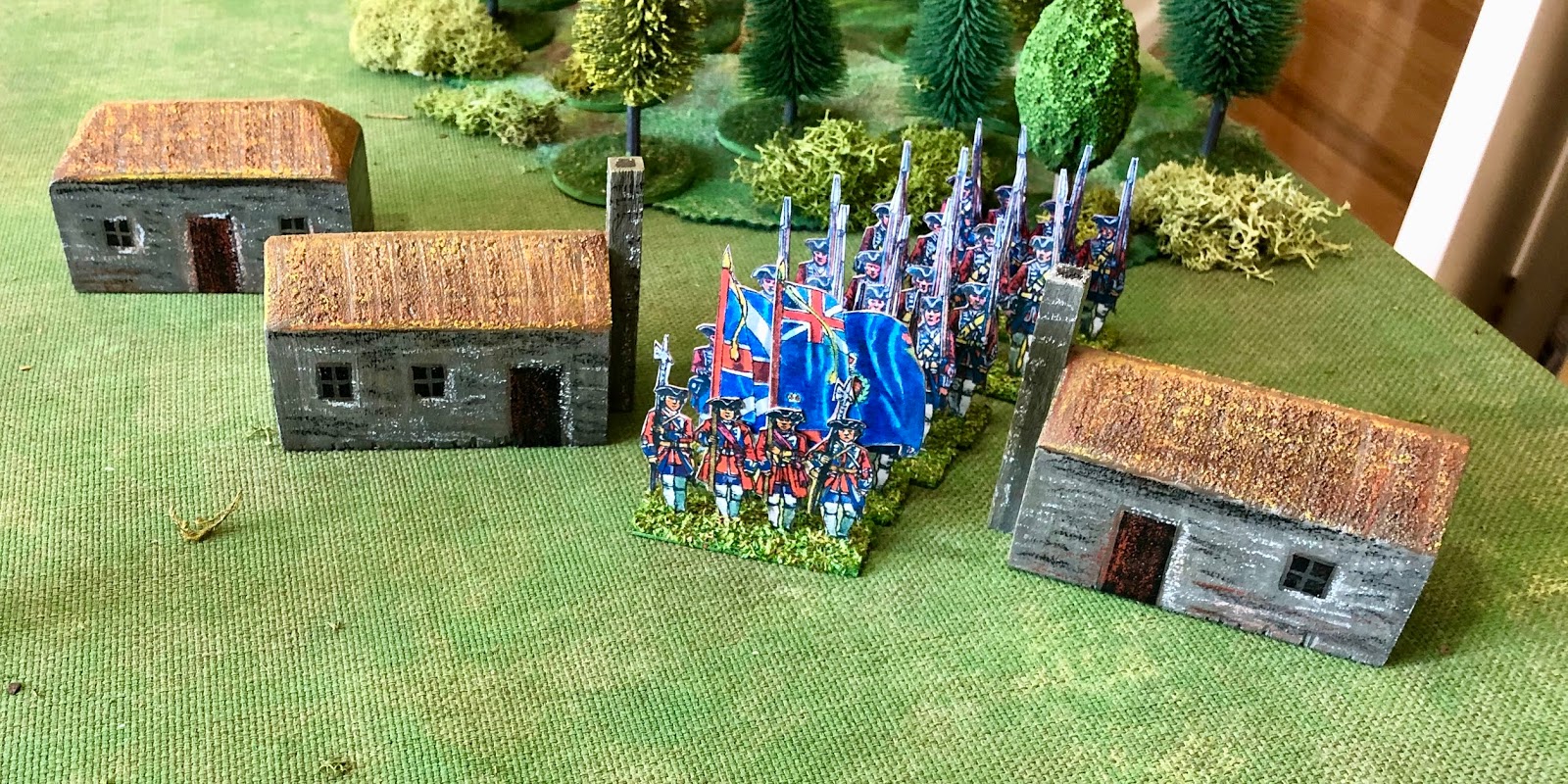 Grid based wargaming but not always More wooden block buildings for