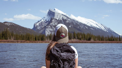 Alone girl with backpack enjoying the mountain landscape