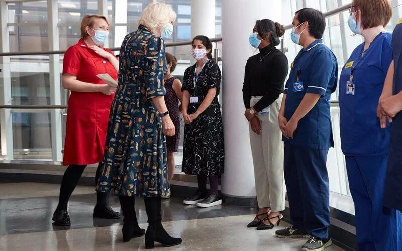 The Duchess of Cornwall wore a navy blue shirt dress with feather print detail