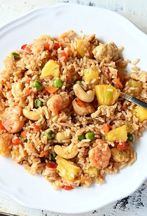 a white plate with pineapple fried rice
