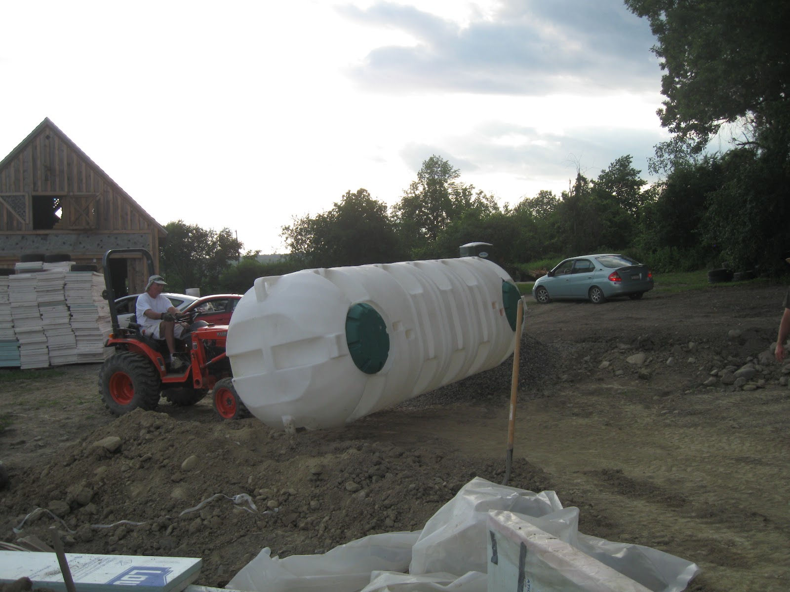 The Freeville Earthship: 2nd tier of thermal wrap, Cisterns in place!