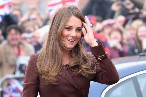 Kate Middleton wrapped up her baby bump in a brown Hobbs coat today when she arrived at the National Fishing Heritage Center