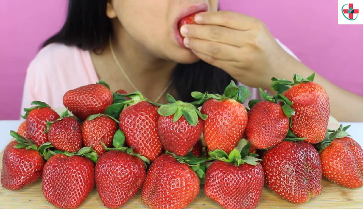 Woman eating fresh strawberries