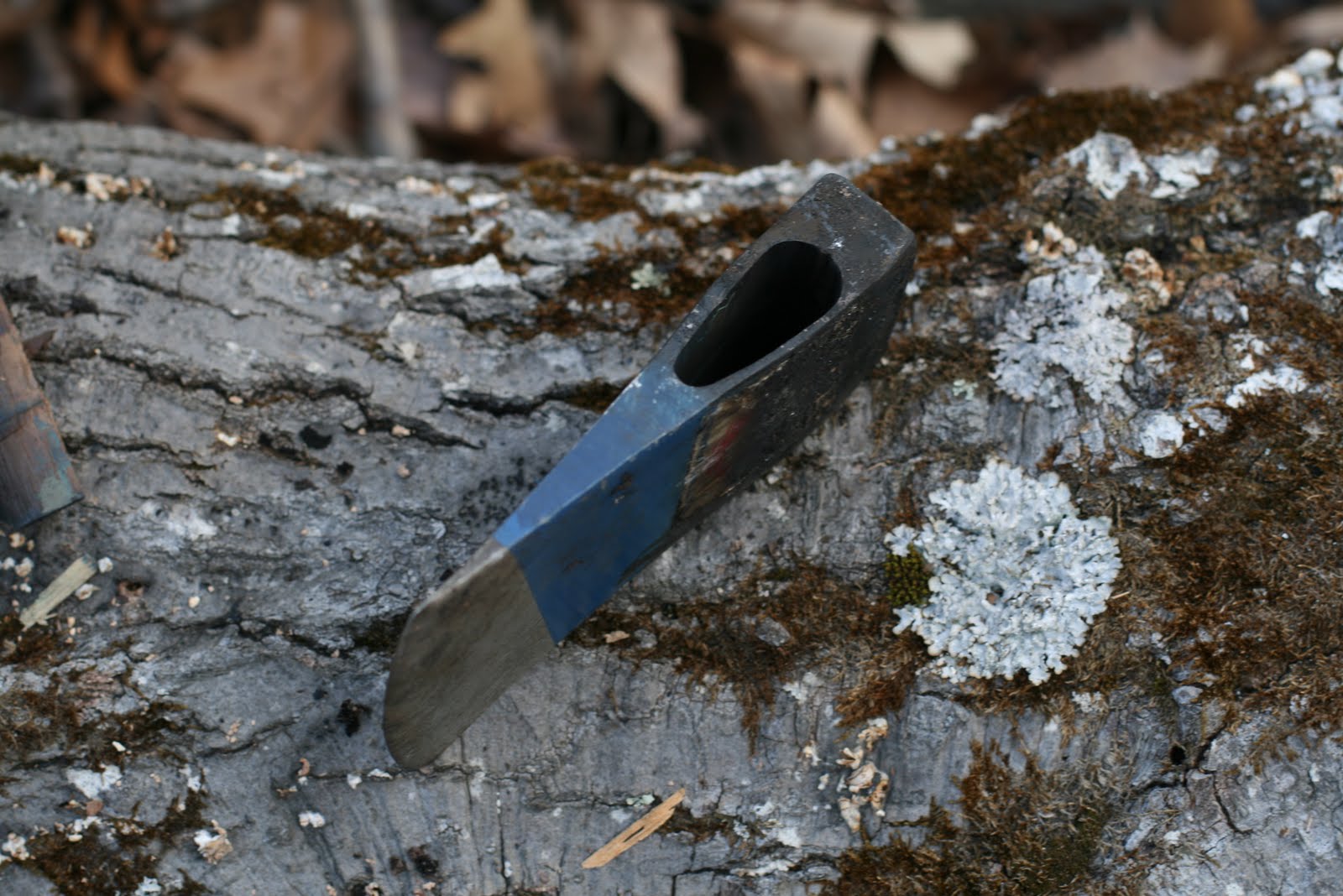 Wood Trekker Removing an Axe Handle in the Woods