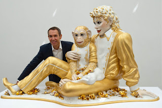 American-artist-Jeff-Koons-poses-next-to-his-artwork-%25E2%2580%259CMichael-Jackson-and-Bubbles%25E2%2580%259D-1988-in-the-Fondation-Beyeler-in-Riehen-Switzerland.jpg