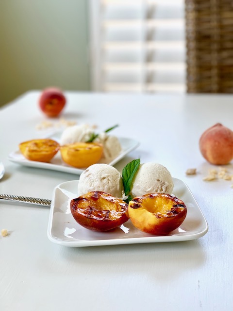 peaches and ice cream on a white table