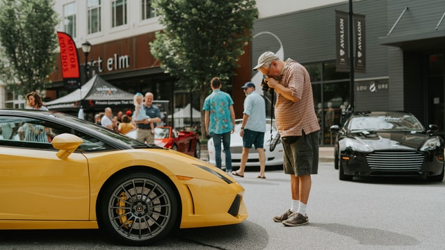 Man Standing in Front of Yellow Car Lamborghini