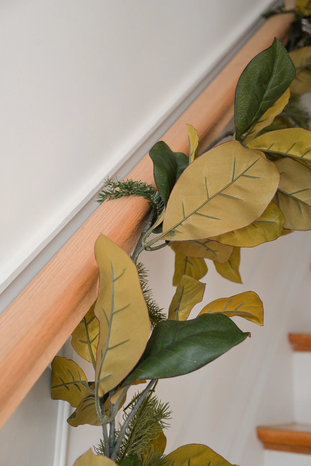 how to hang garland on stairs, stairway garland, garland on stair banister