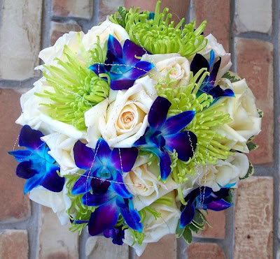 Bouquet of blue orchids and green Spider Mums. Cream roses add a beautiful contrast to the cool greens and blues.