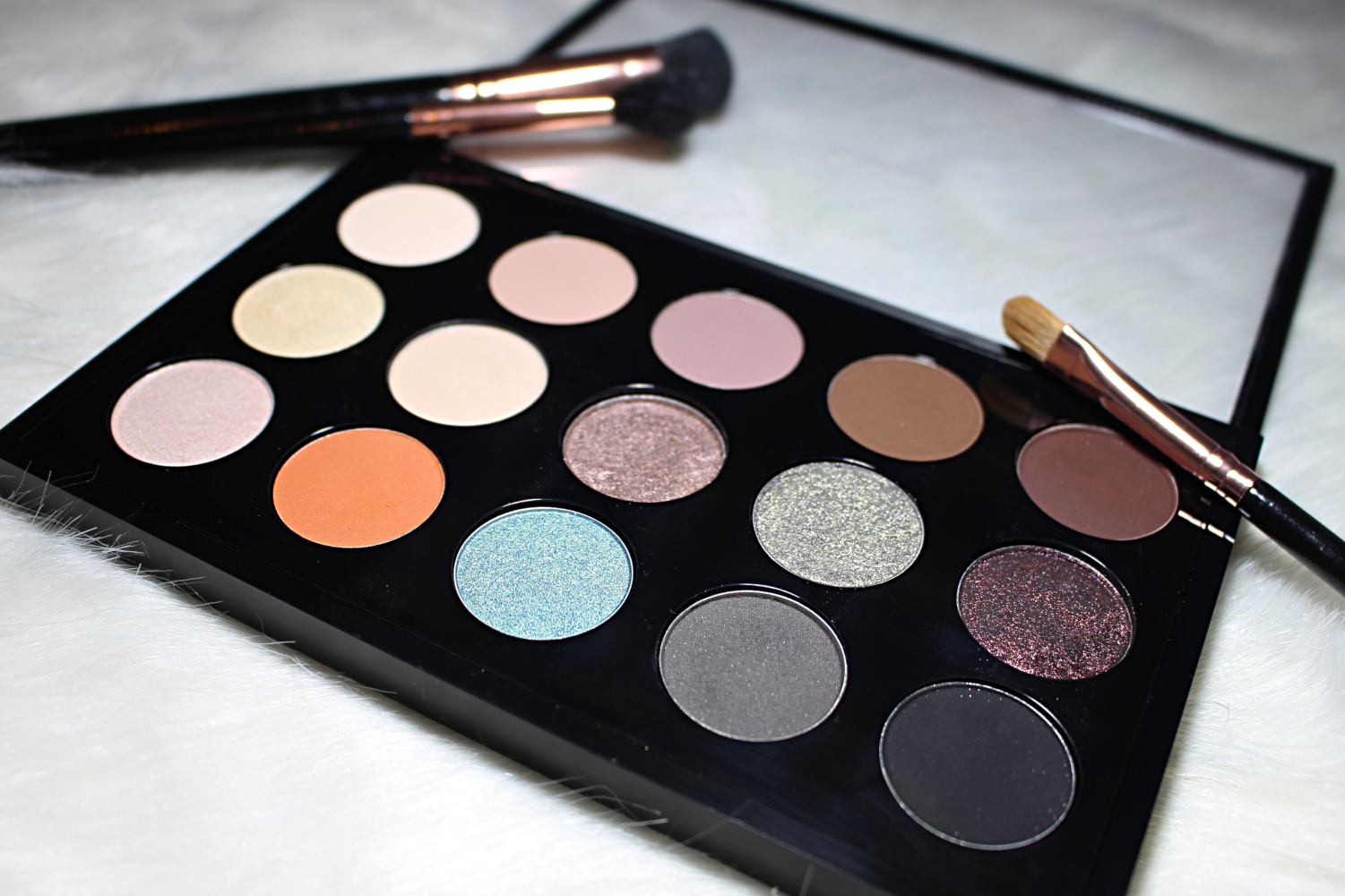 a close-up of an eyeshadow pro palette by mac cosmetics filled with single eyeshadow pans