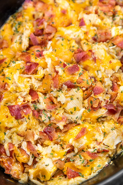 Slow Cooker Crack Chicken and Rice - a quick and easy weeknight recipe! Just dump everything in the slow cooker and dinner is done! Only a few simple ingredients - chicken, ranch dressing mix, bacon, cheddar cheese, cream of chicken soup, milk and rice. Can add some mixed veggies too! Everyone cleaned their plate! Leftovers taste great too! YUM! #crockpot #slowcooker #chicken #rice crockpot chicken and rice