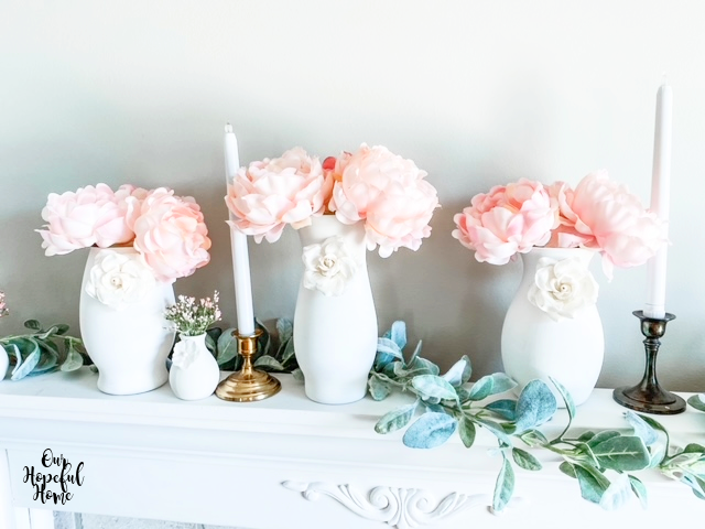 white paper flowers pink peonies vases mantel brass candlestick