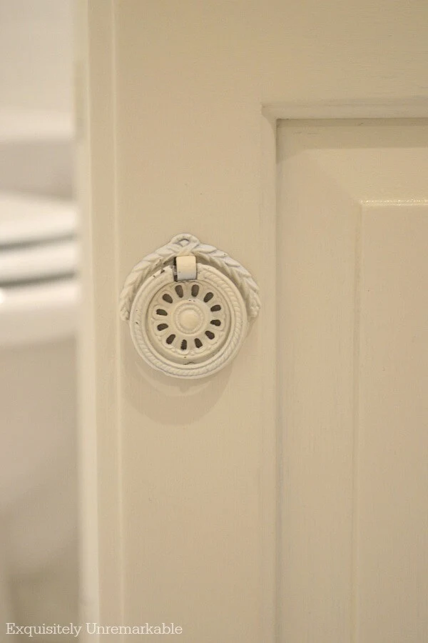 White painted vintage bathroom hardware on ivory vanity