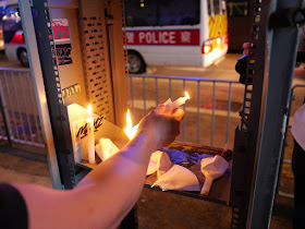 placing a lit candle with a police vehicle in sight