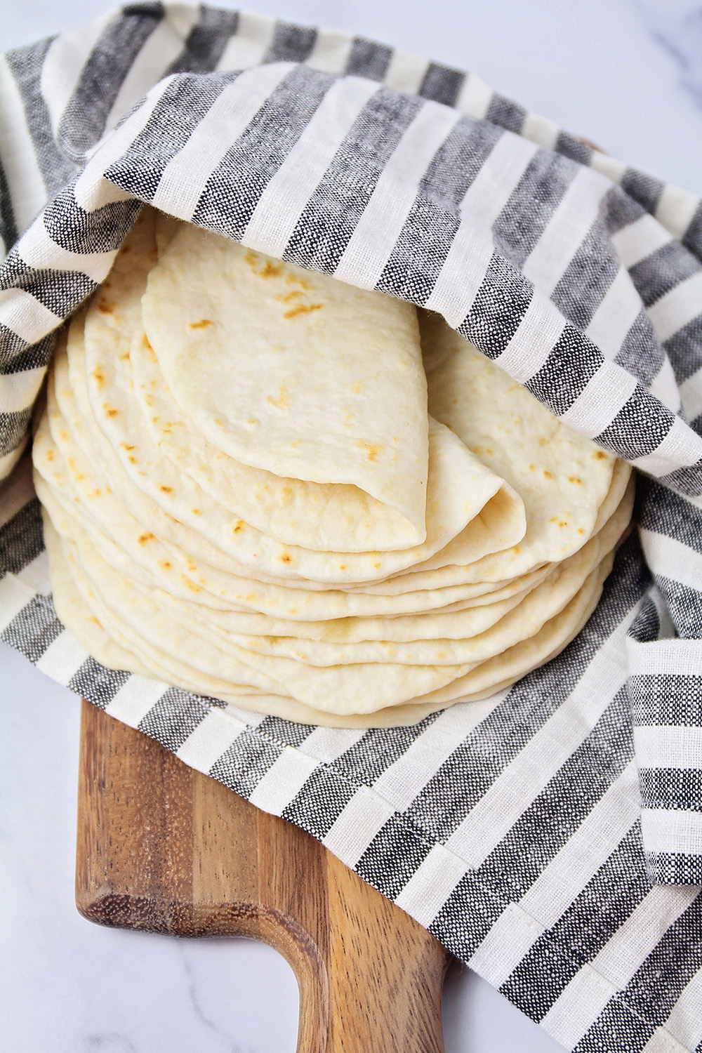 These soft homemade flour tortillas are perfect for tacos, enchiladas, burritos, and more! They're so delicious and so easy to make!