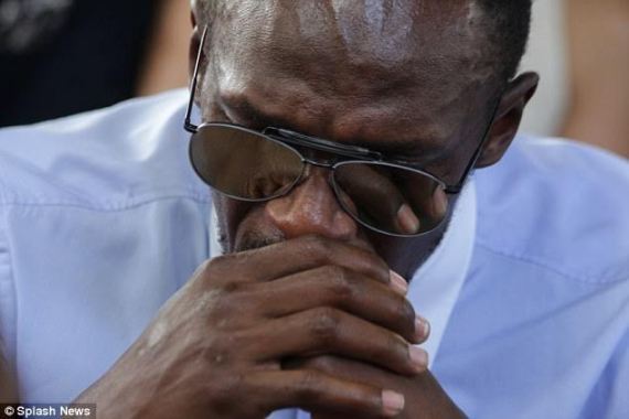 Usain Bolt cries as he serves as pallbearer at the funeral of his late  friend/Olympic silver medallist, Germaine Mason