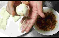 Making round shape stuffed dough ball between the palm of hands