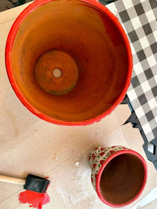 Painting a red rim on the flower pot