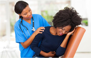 Black woman suffering from uterine fibroids