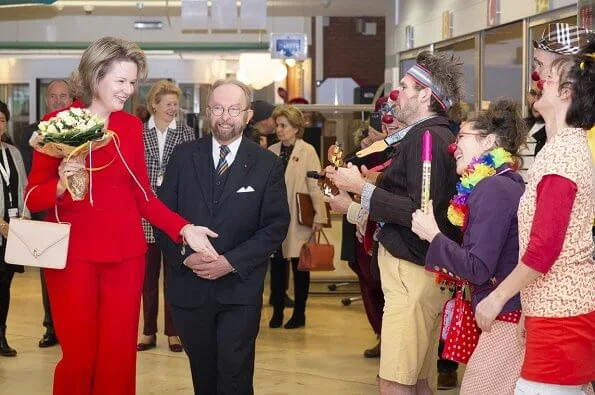 Queen Mathilde visited Queen Fabiola Children's University Hospital. The Queen wore a double breasted orange blazer by Ralph Lauren