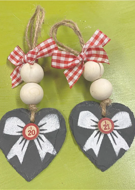 Two heart ornaments with stenciled bows