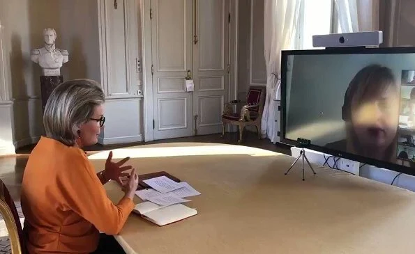 Queen Mathilde is honorary president of Unicef Belgium. Queen Mathilde wore a new orange silk blouse top from Natan, and orange earrings