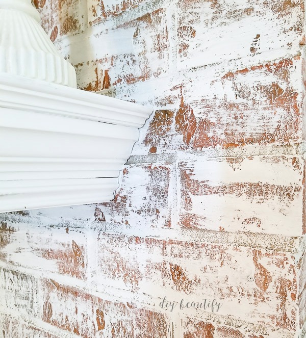 Transform your dirty and dated brick fireplace in a couple of hours! I'm sharing my technique that is easy, mess-free and quick! Find out more at diy beautify! close up of painted fireplace | diybeautify.com