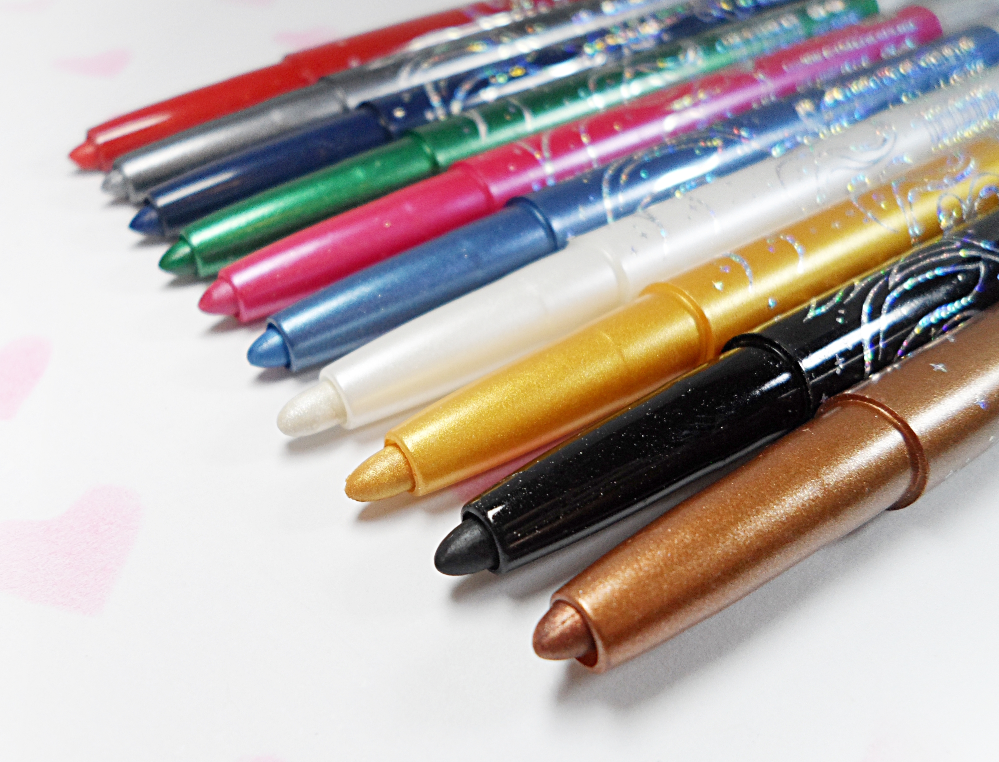 a stack of cheap, makeup pencils in a studio on a plain background
