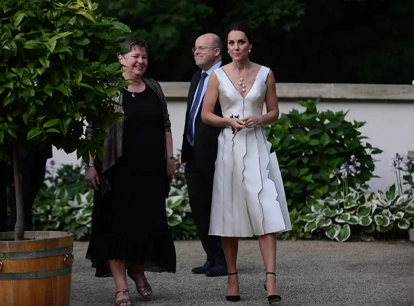 Kate Middleton wore Gosia Baczynska dress and Balenciaga earrings. Kate Middleton carried PRADA Satin Clutch
