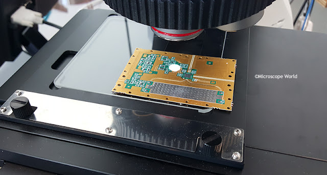 Microscope mechanical stage with circuit board.