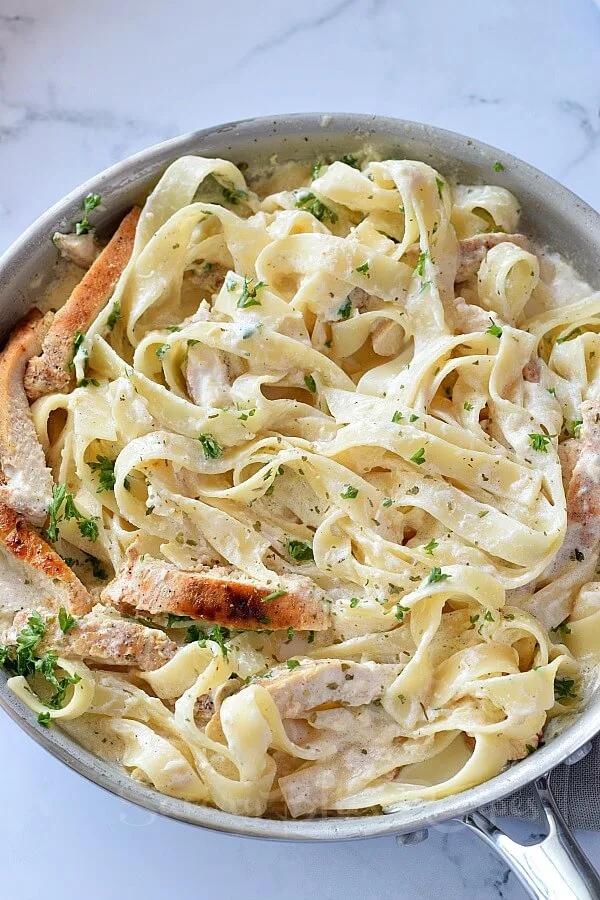 a pan with creamy chicken fettuccine alfredo with homemade alfredo sauce