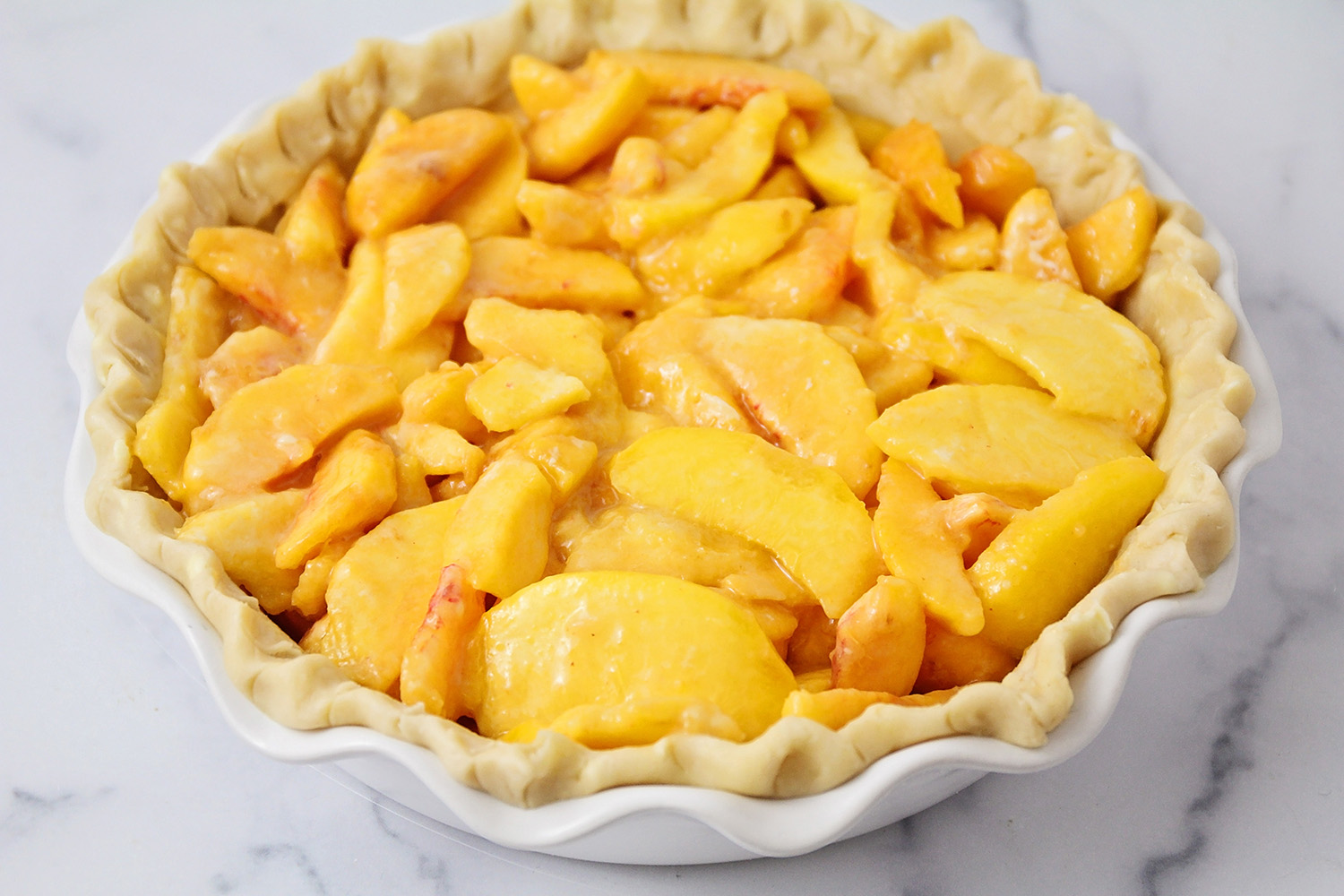 This peach crisp pie is loaded with juicy fresh peaches, all covered with buttery cinnamon crisp topping!