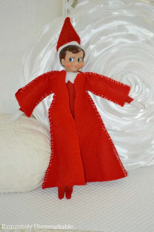 Elf On The Shelf Wearing a red felt coat