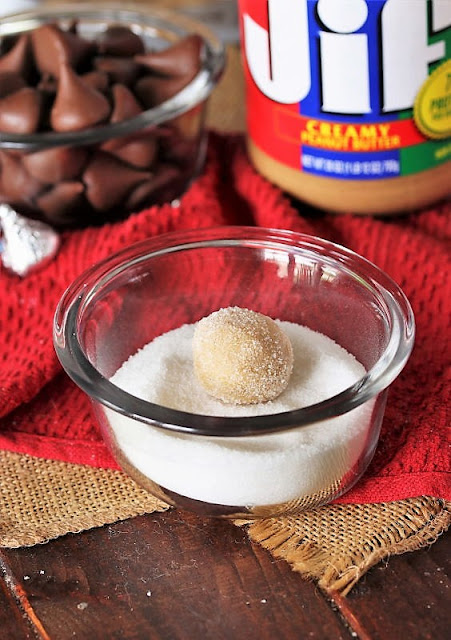 Rolling Peanut Butter Blossoms Dough Balls in Sugar Image