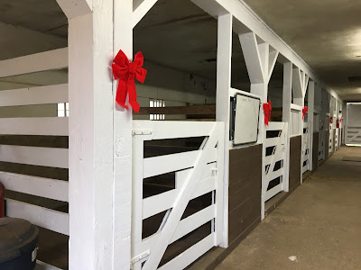 Red ribbons outside each horse stall in the barn