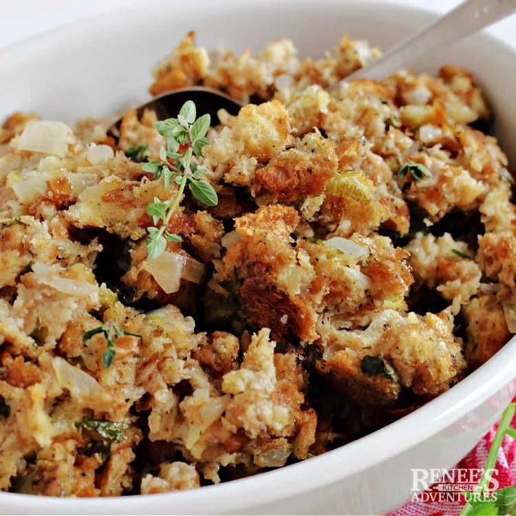 Sage and Onion Stuffing in a white serving dish ready to eat