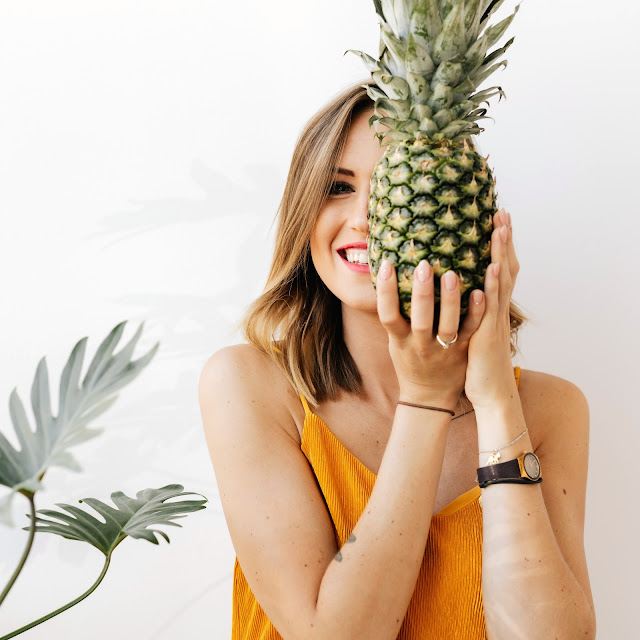 Woman holding a summer pineapple