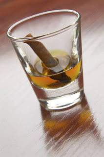 Cigarette in a shot glass.