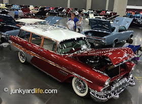A beautiful Candy Apple red 1957 Pontiac wagon takes the floor at POCI show.