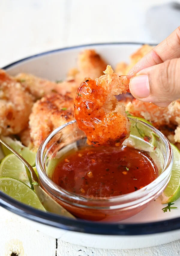 baked healthy coconut shrimp dipped in dipping sauce