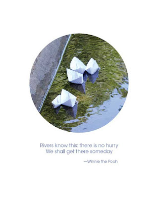 paper boats sailing down a street with quote