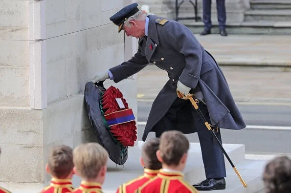 Kate Middleton wore a bespoke black military coat by Alexander McQueen, and a Philip Treacy hat. Queen's diamond and pearl earrings