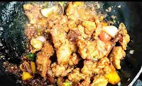 Fried chicken with vegetables and sauces in a pan for chilli chicken recipe